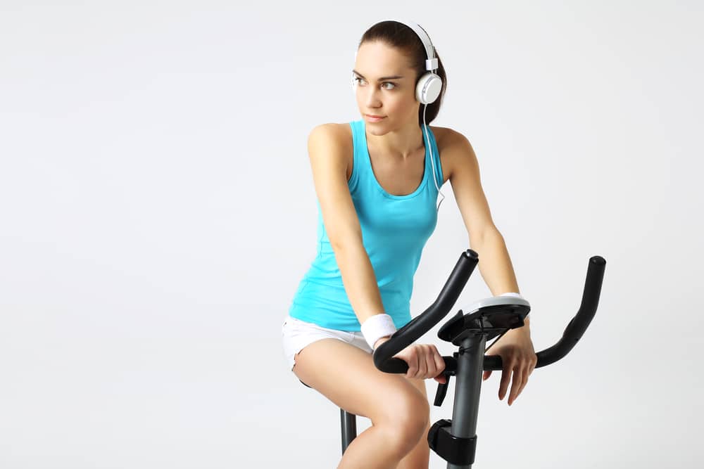 Mujer entrenando en bicicletas estáticas baratas